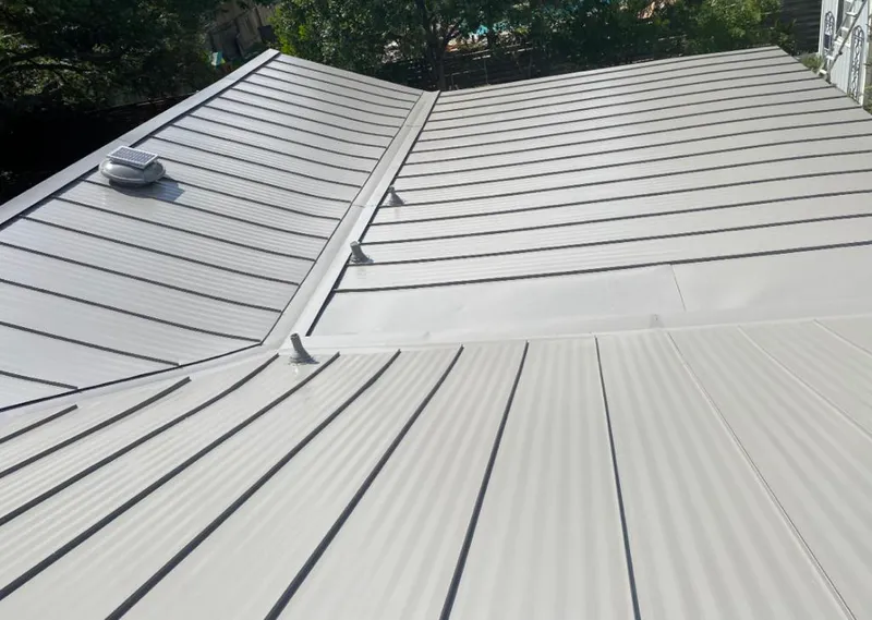 Solar attic fan installed on a metal roof for Roof Ventilation in Chicago